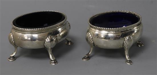 A matched pair of George III silver oval salts, on hoof feet.